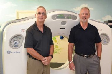 Chambliss brothers standing in front of scanning machine